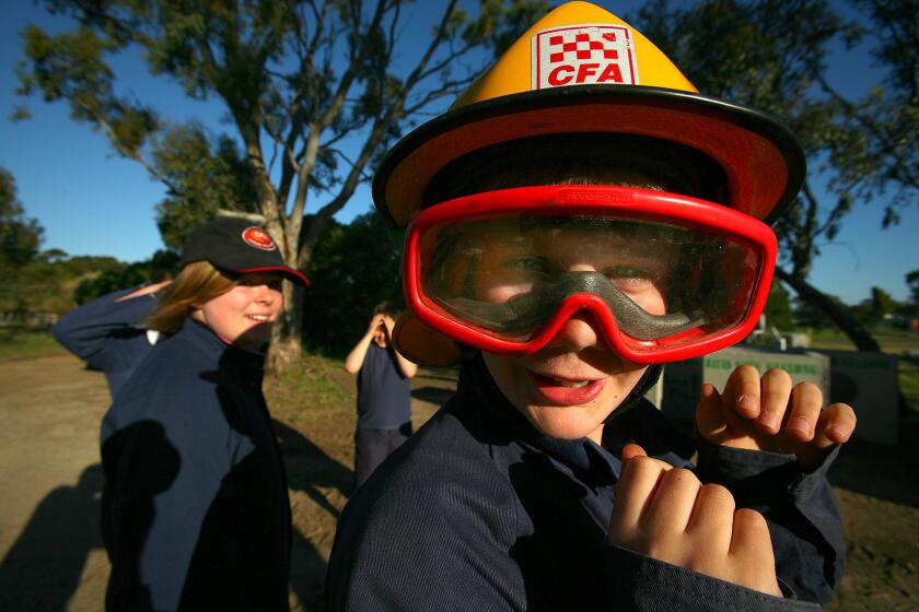 Liam Hodges, a 12-year-old "junior firey," receives training from the County Fire Authority in Anakie, Australia.