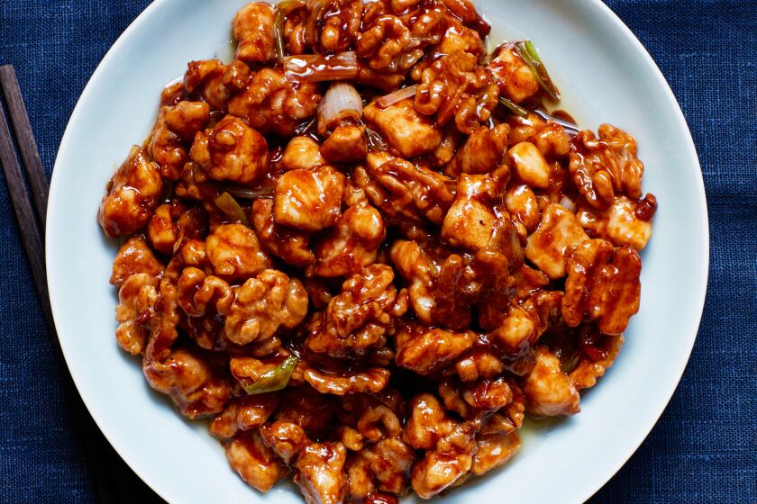 A salty-sweet fermented yellow bean paste sauce coats chicken and walnuts.