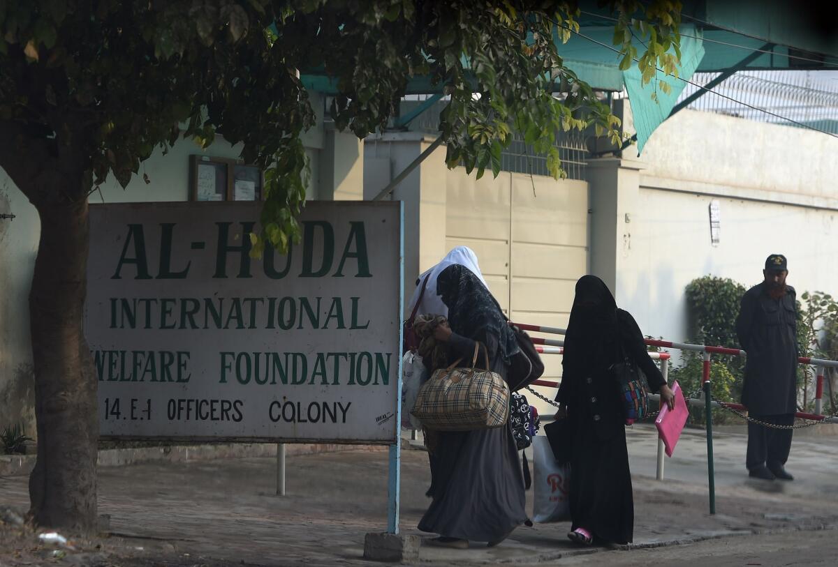 Pakistani students arrive Monday at Al Huda, a women-only seminary in Multan, Pakistan, where San Bernardino shooter Tashfeen Malik studied.