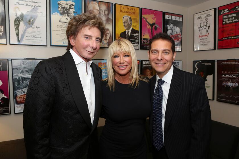 From left, composer Barry Manilow, actress Suzanne Somers and singer-musician Michael Feinstein pose backstage after the opening night performance of "Harmony" at the Ahmanson Theatre.