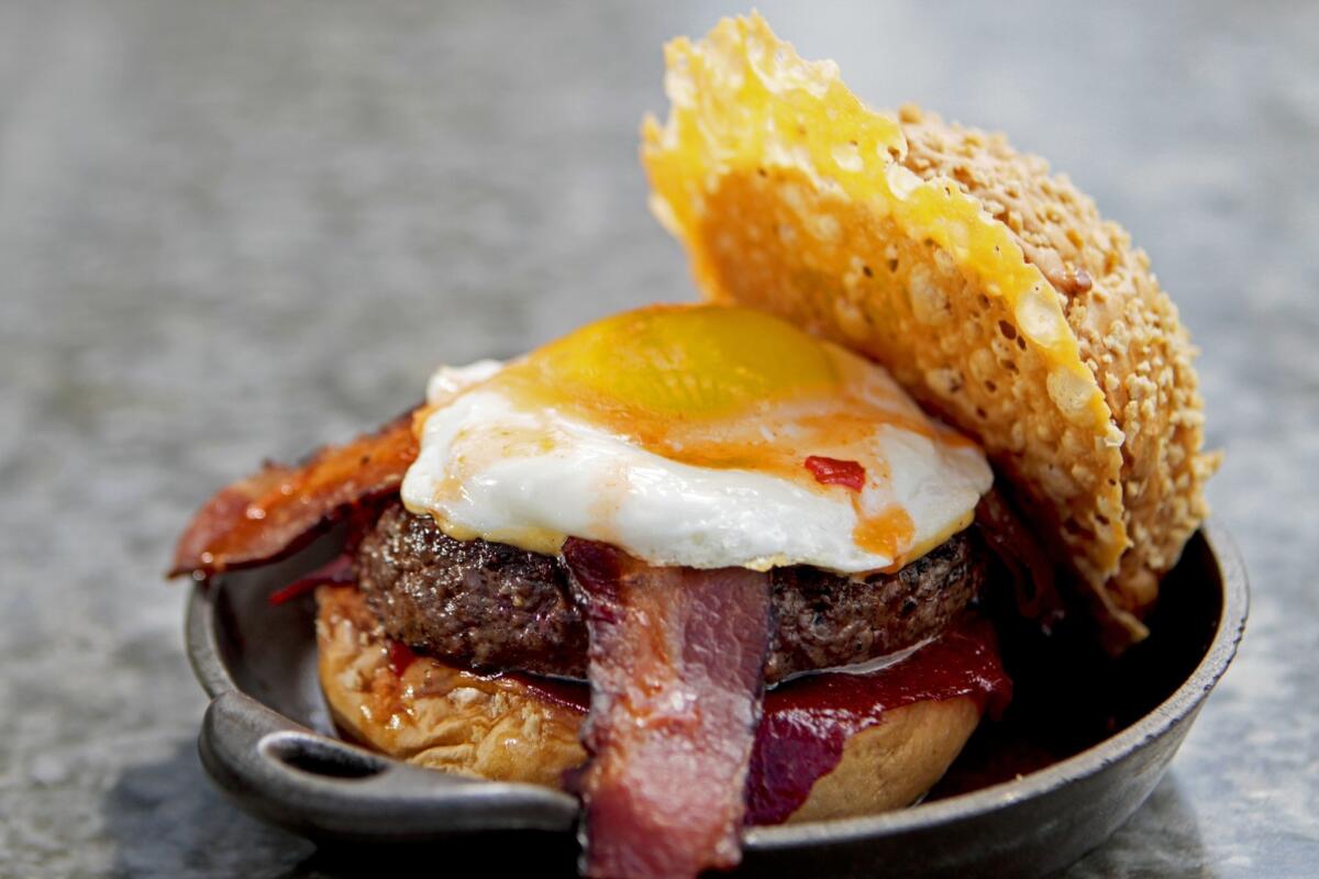 The Chef's Favorite Burger, made with cheese two ways, ketchup leather, a fried egg, hot sauce and bacon at Plan Check Kitchen + Bar. The restaurant will open a location in downtown L.A. on Oct. 20.