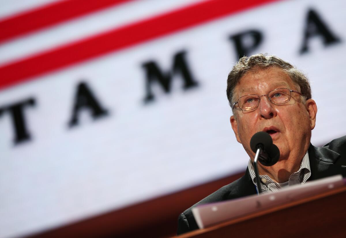 Former New Hampshire Gov. John Sununu stands at the podium on the abbreviated first day of the Republican National Convention in Tampa, Fla.