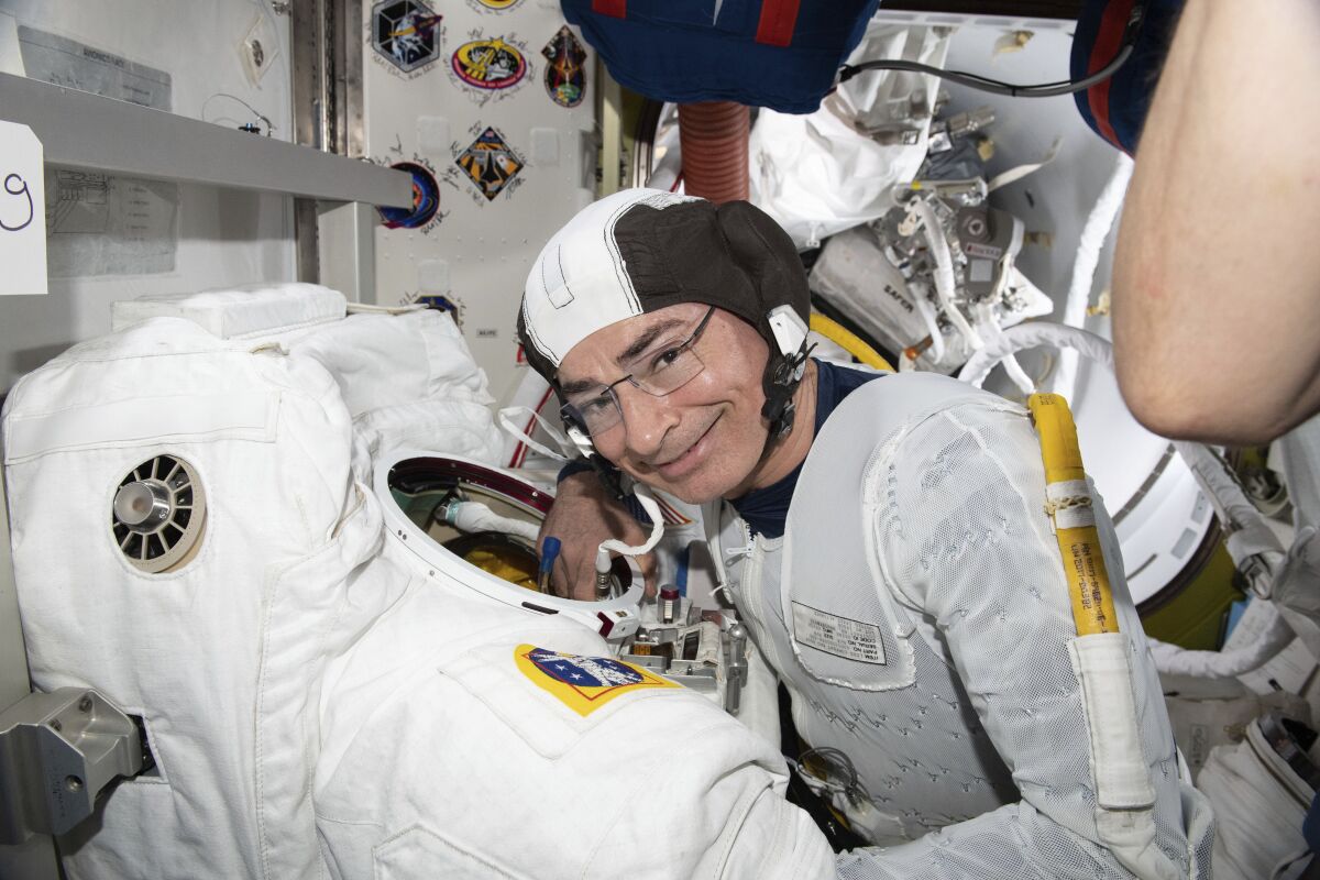 NASA astronaut Mark Vande Hei inspects a spacesuit at the International Space Station. 