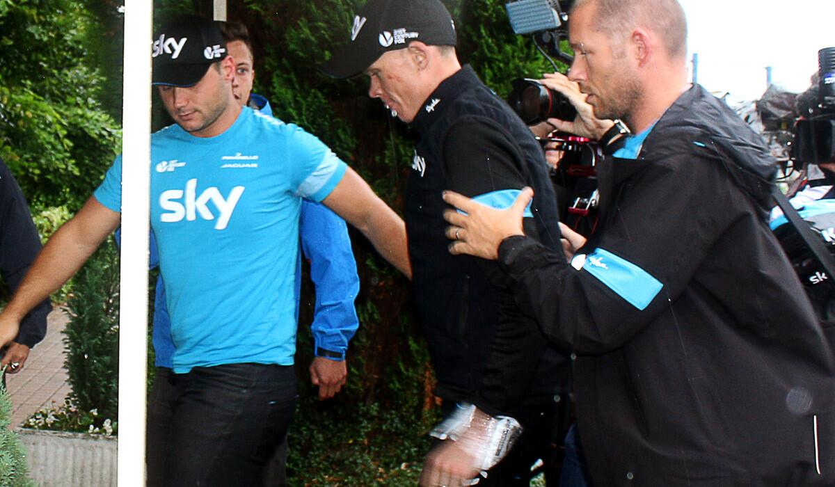 Reigning Tour de France champion Chris Froome (center) arrives at his hotel in Marcq-en-Barul, France, after withdrawing from the race following two crashes during the fifth stage on Wednesday.