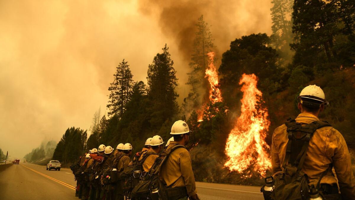 Firefighters monitor the Delta fire along Interstate 5 north of Redding on Sept. 7.