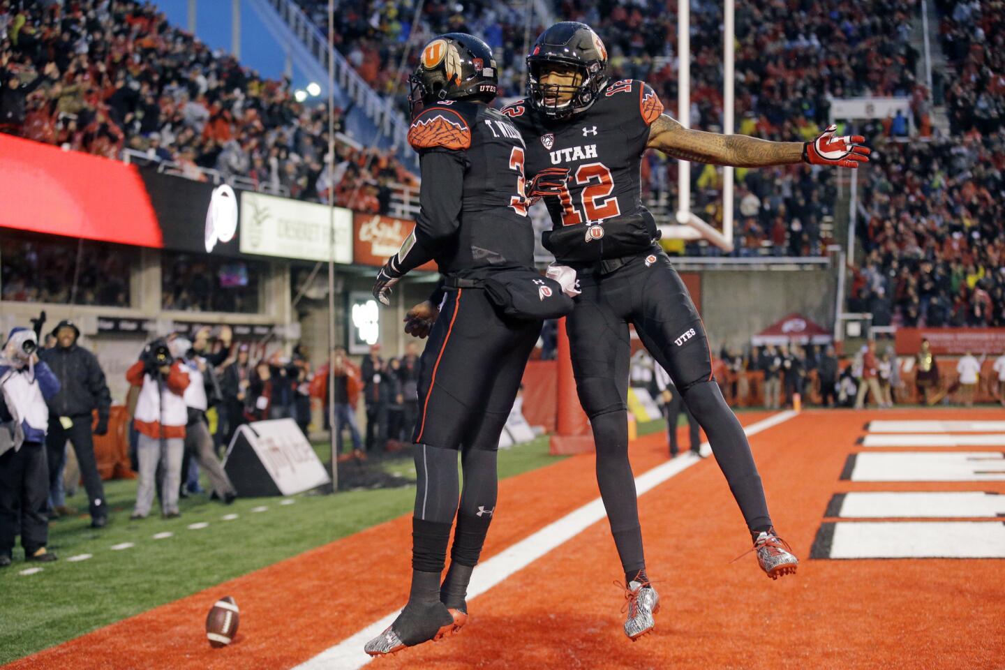 Utah quarterback Troy Williams (3) celebrates with teammate Tim Patrick (12) after scoring against USC in the first half.