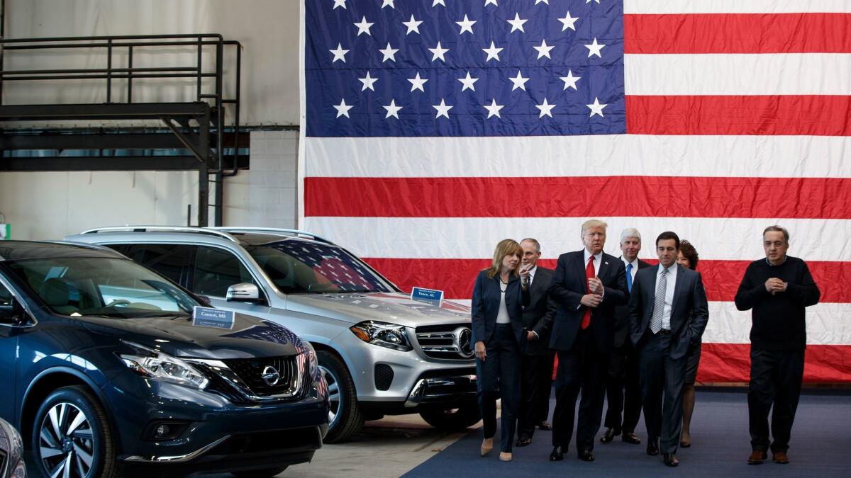 President Trump tours a Detroit-area exhibition on March 15 flanked, from left, by GM CEO Mary Barra, EPA Administrator Scott Pruitt, Michigan Gov. Rick Snyder, Ford CEO Mark Fields, Transportation Secretary Elaine Chao and Fiat Chrysler CEO Sergio Marchionne.