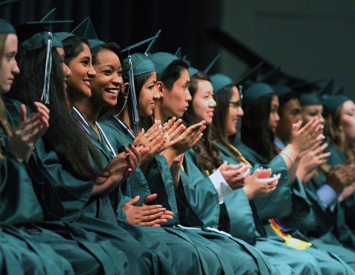 Graduates applaud at the graduation of Providence High School on Saturday, June 7, 2014 at Forest Lawn in the Hall of Liberty in Los Angeles. (Tim Berger/Staff Photographer)