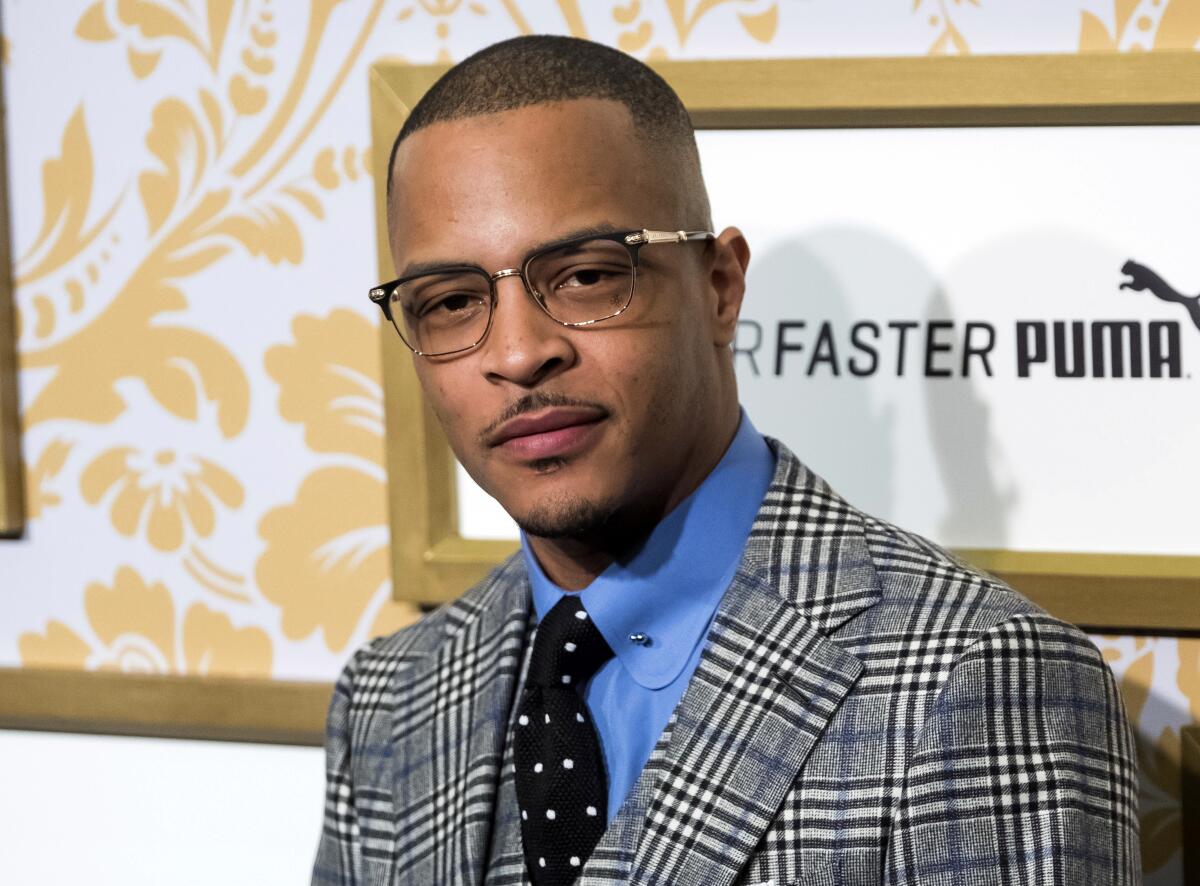 A man wearing glasses, shirt, tie and a plaid blazer