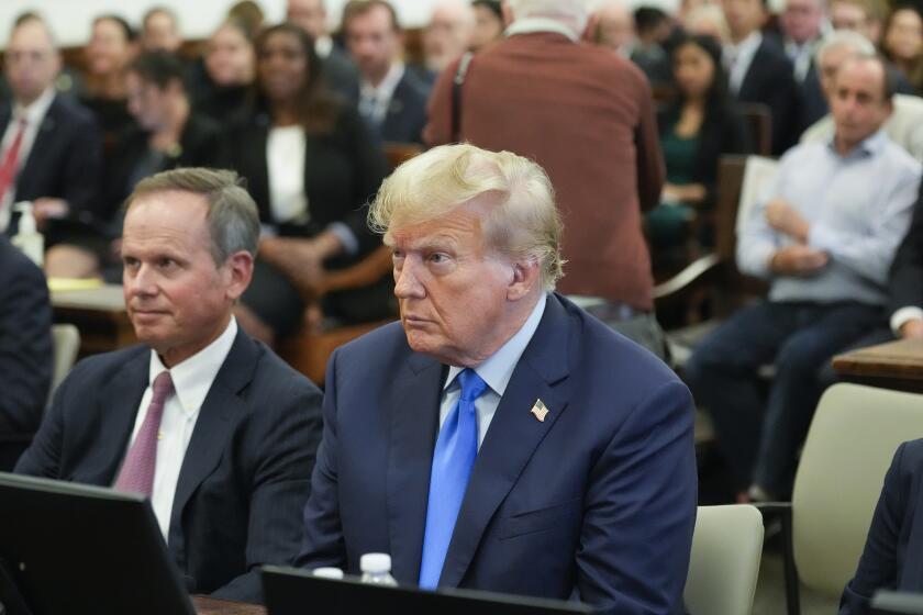 Former President Donald Trump, right, sits in the courtroom at New York Supreme Court, Monday, Oct. 2, 2023, in New York. Trump is making a rare, voluntary trip to court in New York for the start of a civil trial in a lawsuit that already has resulted in a judge ruling that he committed fraud in his business dealings. (AP Photo/Seth Wenig)