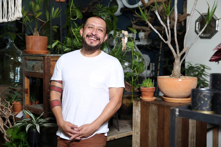 LOS ANGELES, CA - SEPTEMBER 01: Local shop owner of The Juicy Leaf, Felix Navarro, poses for a portrait at his shop in Highland Park on Tuesday, Sept. 1, 2020 in Los Angeles, CA. He has been delivering succulent arrangements to be assembled during his insta live workshops. (Dania Maxwell / Los Angeles Times)