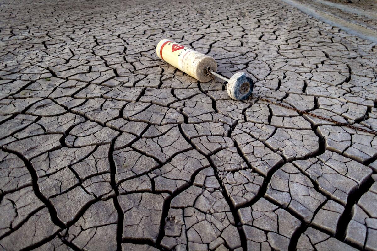 A buoy lies on dried mud at Lake Mead in July 2022.