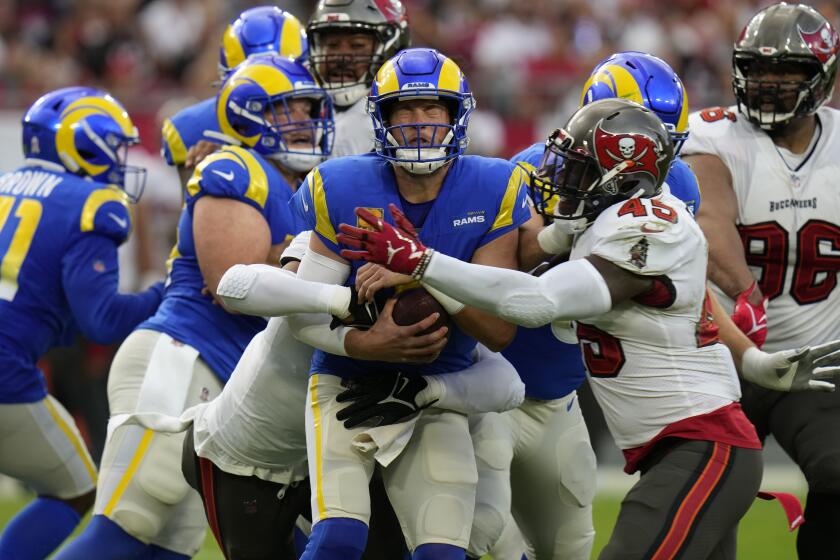 Los Angeles Rams quarterback Matthew Stafford (9) is hit by Tampa Bay Buccaneers linebacker Devin White (45) during the first half of an NFL football game Sunday, Nov. 6, 2022, in Tampa, Fla. (AP Photo/Chris O'Meara)