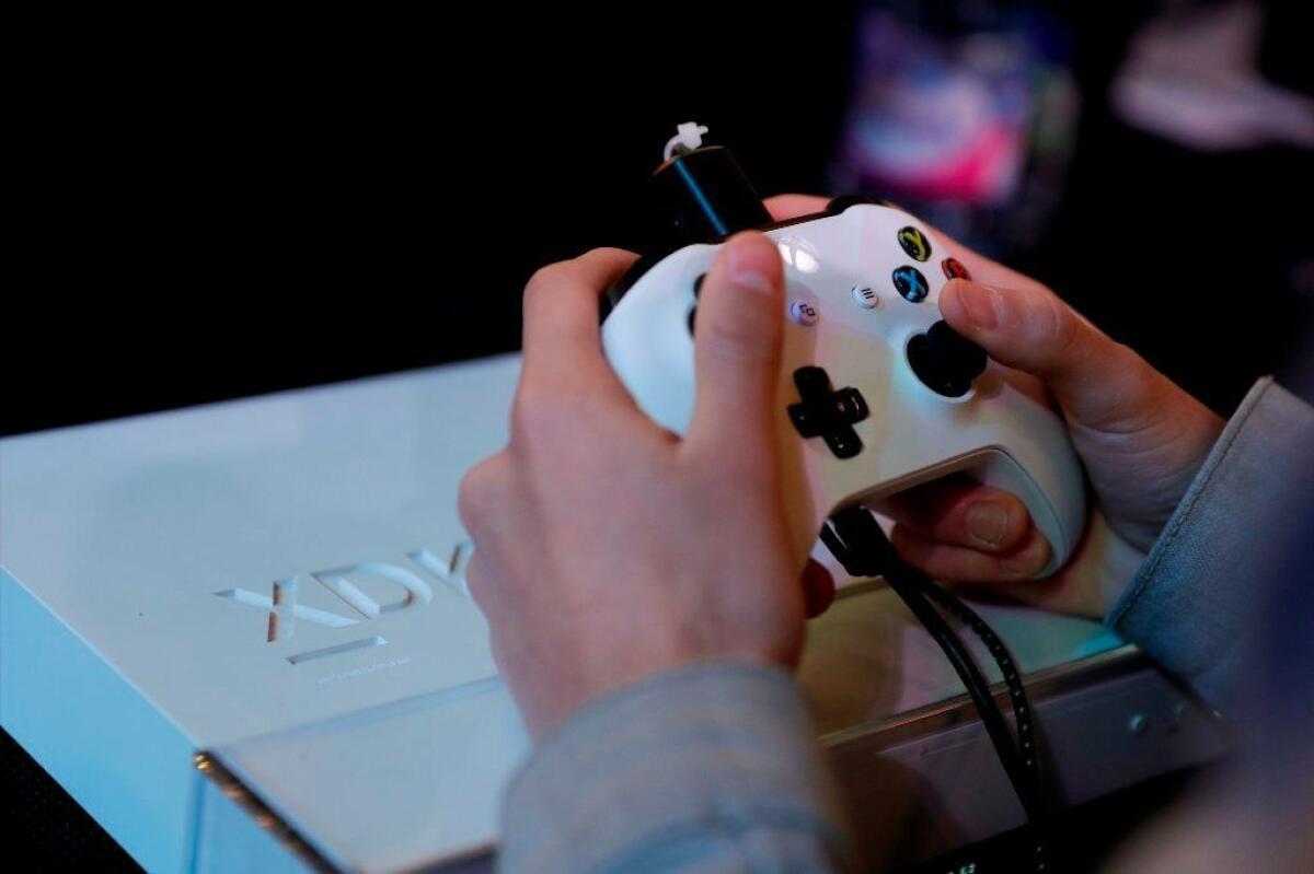 In this file photo taken on Nov. 5, 2017, a gamer plays with an Xbox console during the 2017 Paris Games Week exhibition at the Porte de Versailles exhibition center in Paris.