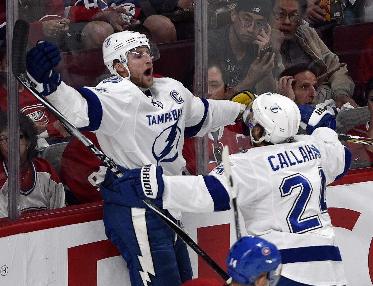 Lightning center Steven Stamkos (91) celebrates with teammate Ryan Callahan (24) after scoring his team's second goal against the Canadiens in Game 2.