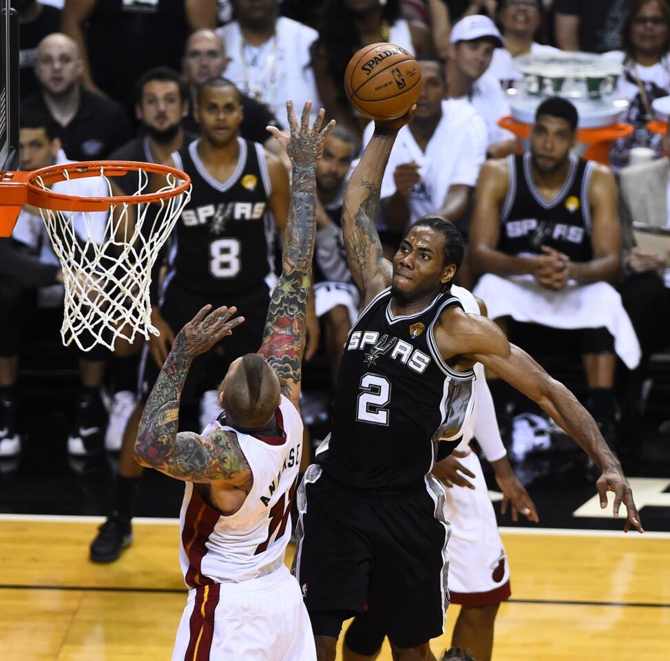 Spurs forward Kahwi Leonard elevates above Heat center Chris Andersen for a dunk in the second half of Game 4.