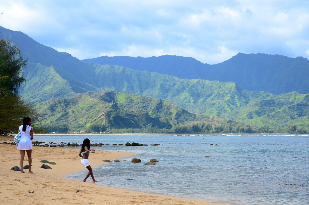 A bather dips a toe into the waters of Hanalei Bay, on the north shore of Kauai, Hawaii. Photo taken 2014.