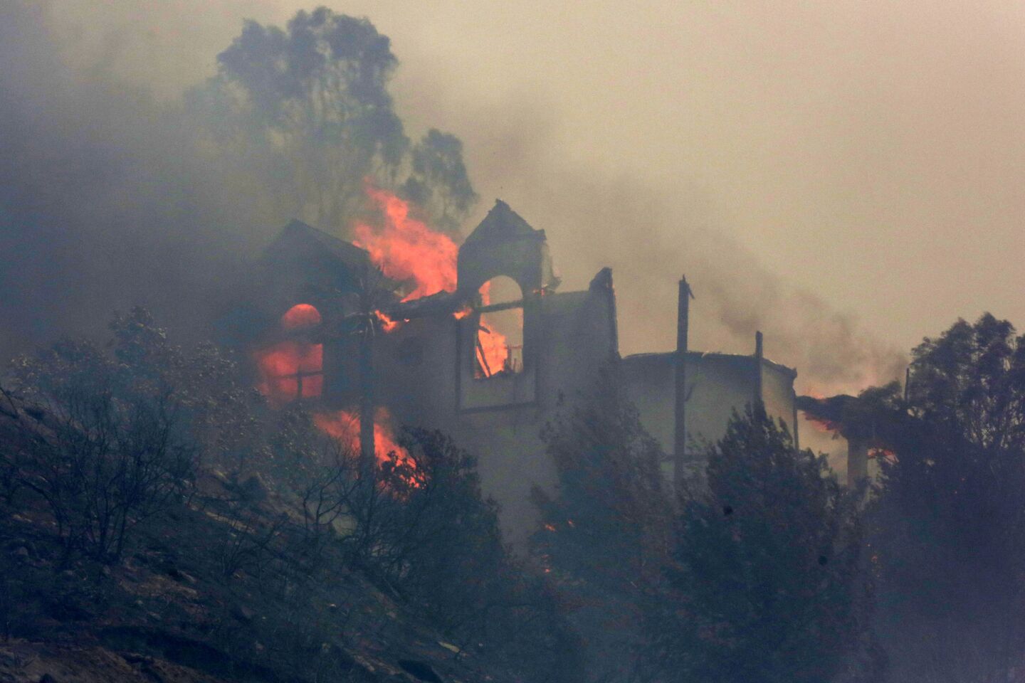 A house burns above Coronado Hills area in San Marcos.