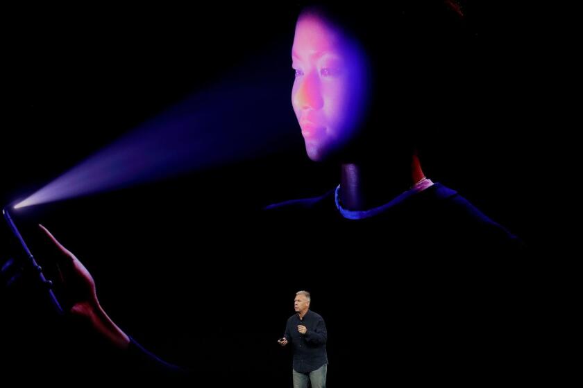 Phil Schiller, Apple's senior vice president of worldwide marketing, announces features of the new iPhone X at the Steve Jobs Theater on the new Apple campus on Tuesday, Sept. 12, 2017, in Cupertino, Calif. (AP Photo/Marcio Jose Sanchez)
