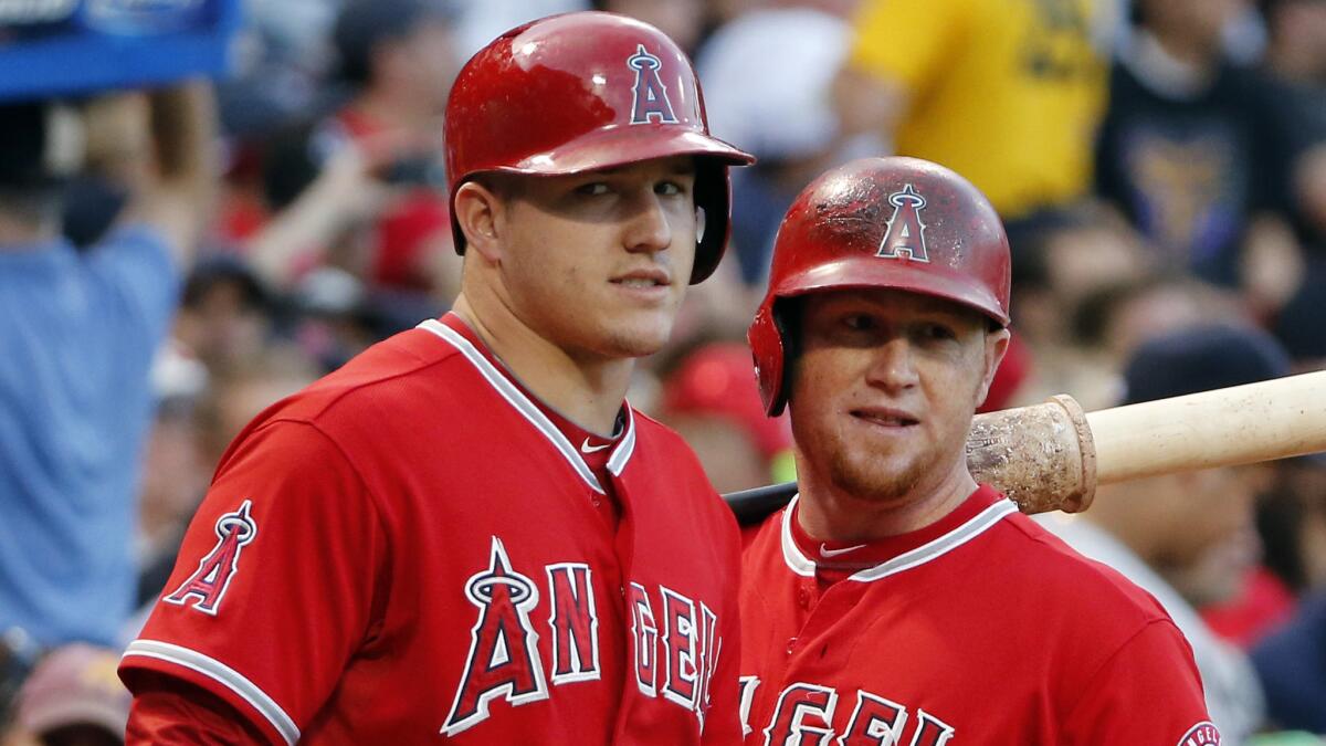 Angels outfielders Mike Trout, left, and Kole Calhoun look on before their first-inning at-bats against the Boston Red Sox on Wednesday.