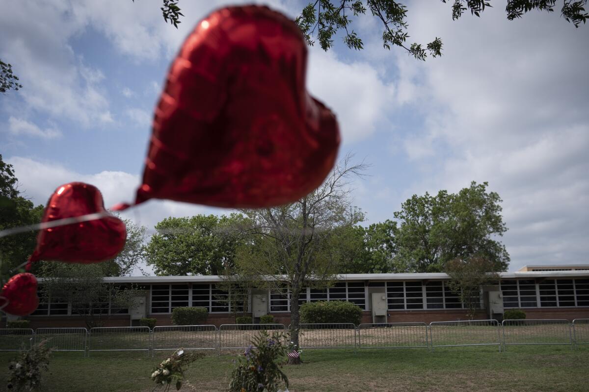 A balloon floats from a makeshift memorial outside Robb Elementary School in Uvalde, Texas, on May 30. 