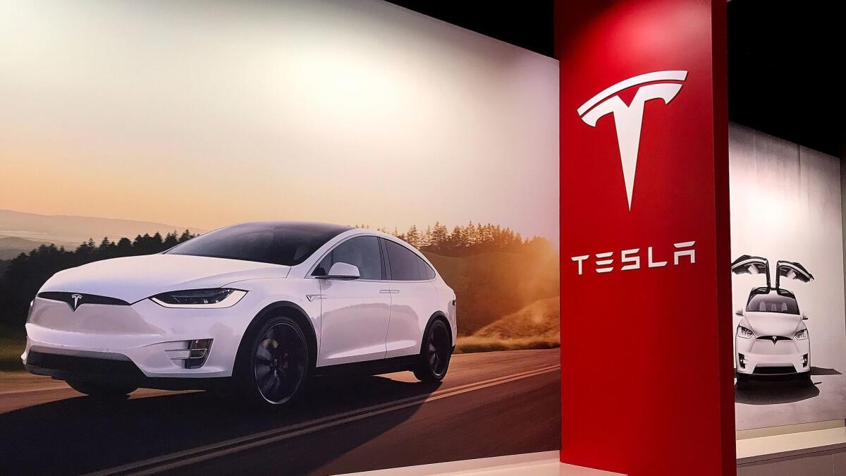 Posters of the Tesla Model X at a Tesla showroom in Corte Madera, Calif., on Aug. 29. The National Labor Relations Board has ordered the automaker to respond to worker complaints.