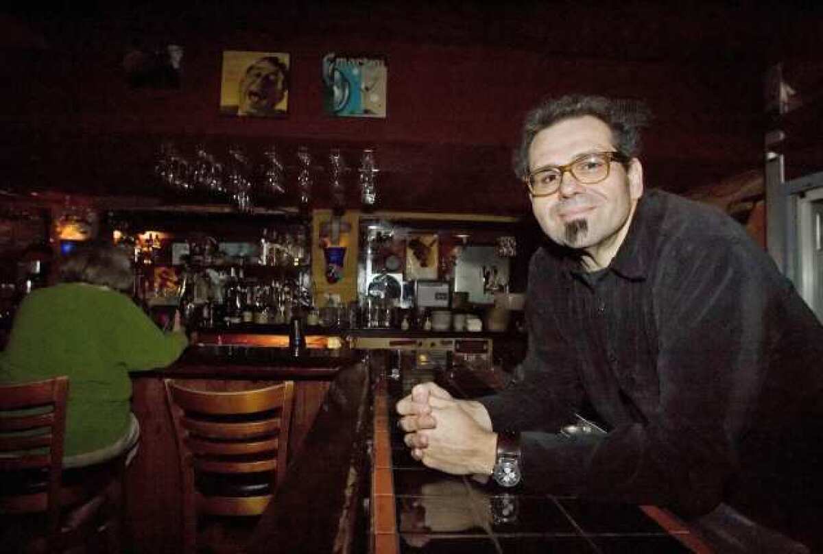 Mario Lalli at Cafe 322 in Sierra Madre. Cafe 322 is a family-run business owned by Mario. Mario is also a musician and has been a major influence on bands like Queens of the Stone Age and Kyuss.