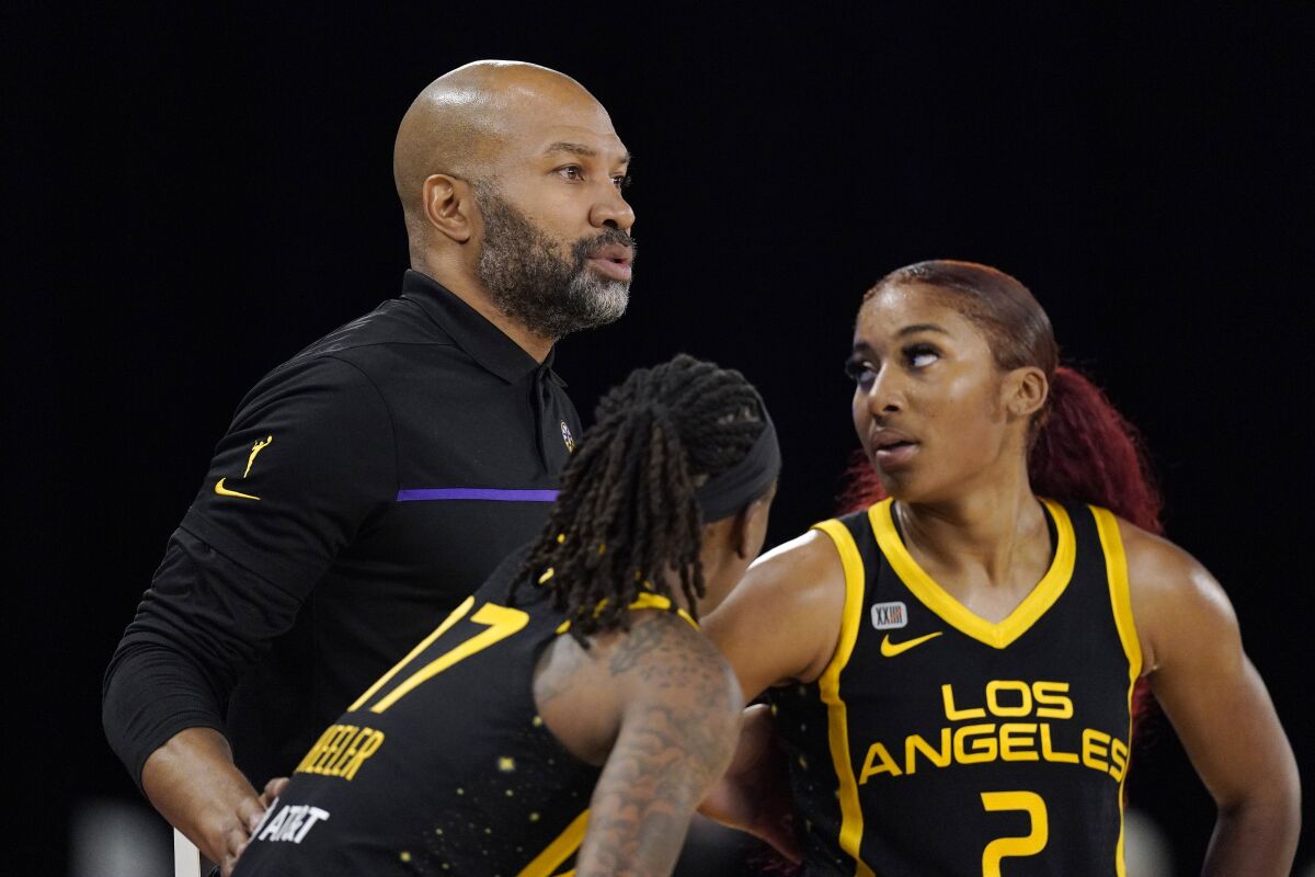 Sparks coach Derek Fisher talks with guards Erica Wheeler and Te'a Cooper during a game.