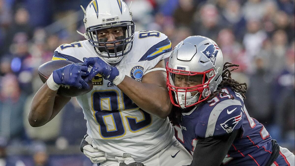 Chargers tight end Antonio Gates pulls down a 12-yard pass as he is tackled by New England Patriots linebacker Dont'a Hightower during fourth quarter Sunday.