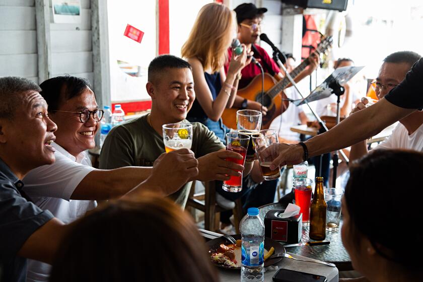 Patrons enjoy beers and live music at Chit Beer, a bar and brewing academy on Koh Kret island outside Bangkok.