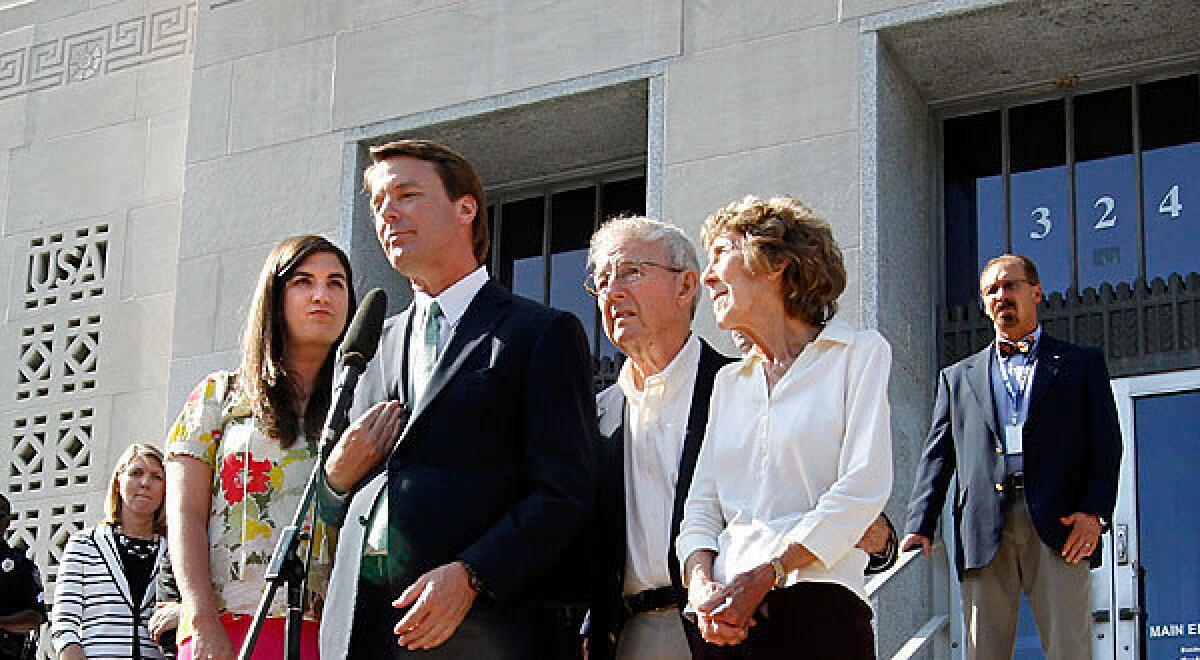 Former Sen. John Edwards addresses the news media alongside his daughter Cate Edwards and his parents, Wallace and Bobbie Edwards, outside federal court in Greensboro, N.C., where a mistrial was declared in the campaign finance case against him. Experts say they doubt federal prosecutors will attempt to retry the case.