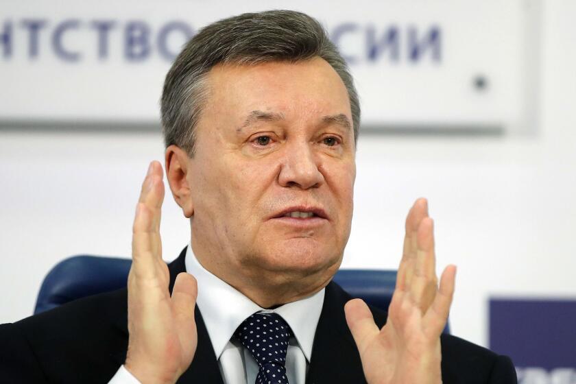FILE - In this March 2, 2018 file photo, former Ukraine President Viktor Yanukovych gestures as he speaks at a news conference in Moscow. A court in the Ukrainian capital Kiev on Thursday Jan. 24, 2019, has found former president Viktor Yanukovych guilty of treason. (AP Photo/Pavel Golovkin, File)