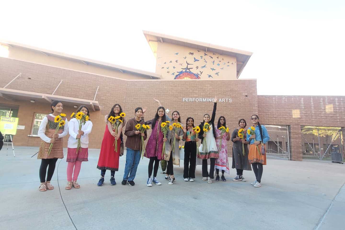 9th graders lined up to hand out sunflowers to fellow students.jpg