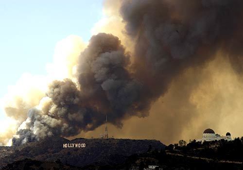 Smoke floats above the Hollywood sign from a brush fire that started in the hills above the Oakwood Apartments.