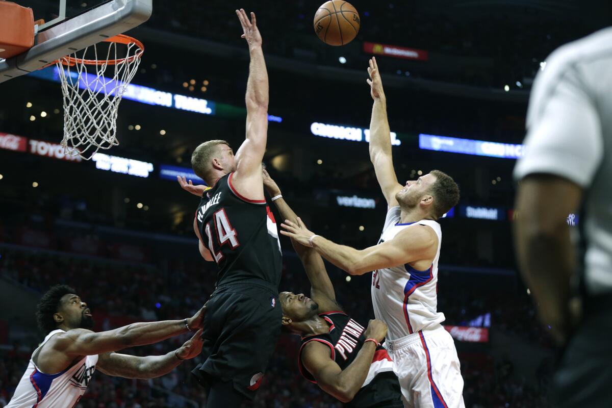 Clippers forward Blake Griffin launches a shot over Trail Blazers forward Maurice Harkless, but it is rejected by center Mason Plumlee in Game 2.