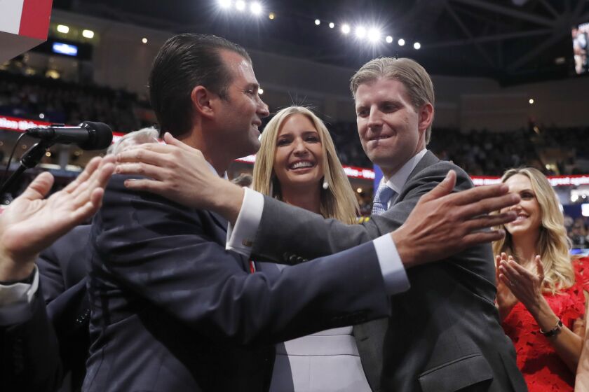 Republican Presidential Candidate Donald Trump's children Donald Trump, Jr., Ivanka Trump, and Eric Trump celebrate on the convention floor during the second day session of the Republican National Convention in Cleveland, Tuesday, July 19, 2016. (AP Photo/Carolyn Kaster)