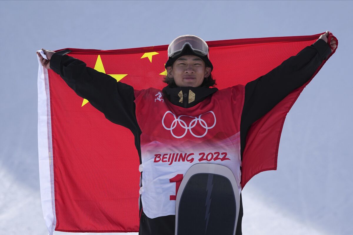 Silver medalist China's Su Yiming celebrates during the award ceremony for the men's slopestyle at the 2022 Winter Olympics, Monday, Feb. 7, 2022, in Zhangjiakou, China. (AP Photo/Gregory Bull)
