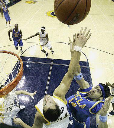 UCLA's Lorenzo Mata, right, shoots over California's Ryan Anderson.