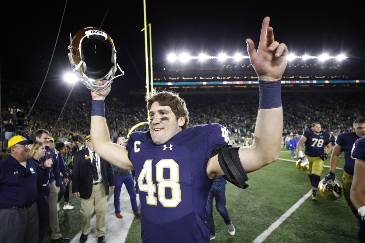 Linebacker Greer Martini celebrates after the Irish's 49-14 victory over the Trojans.