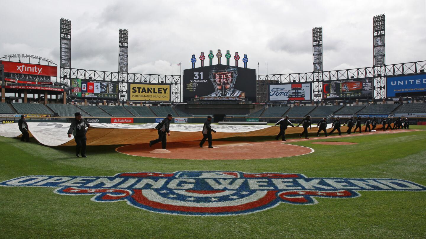 The grounds grew takes off the rain tarp in preparation for opening day at U.S. Cellular Field for a game between the Chicago White Sox and Cleveland Indians Friday, April 8, 2016, in Chicago.