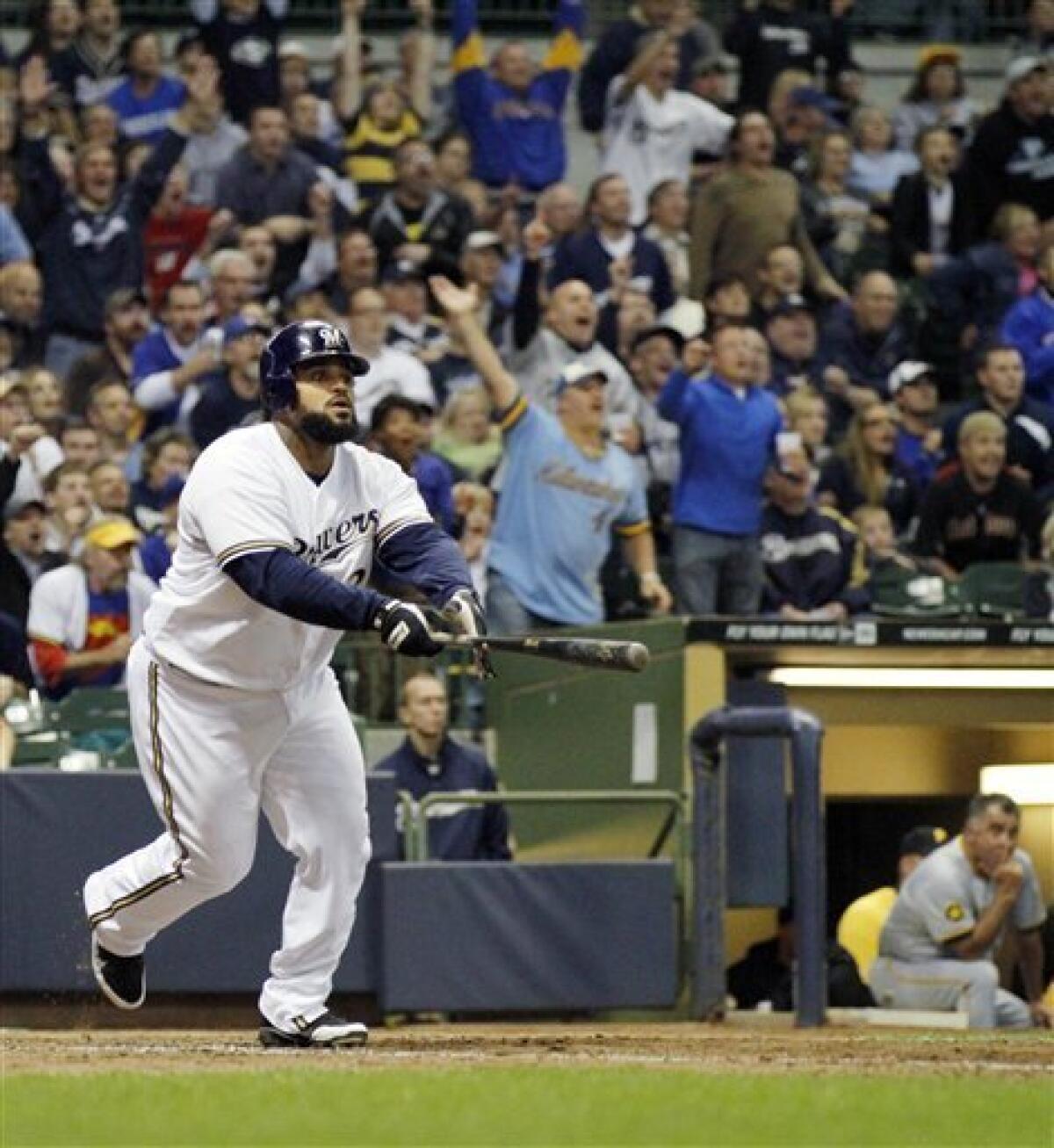 Milwaukee Brewers Prince Fielder walks off the field with wife