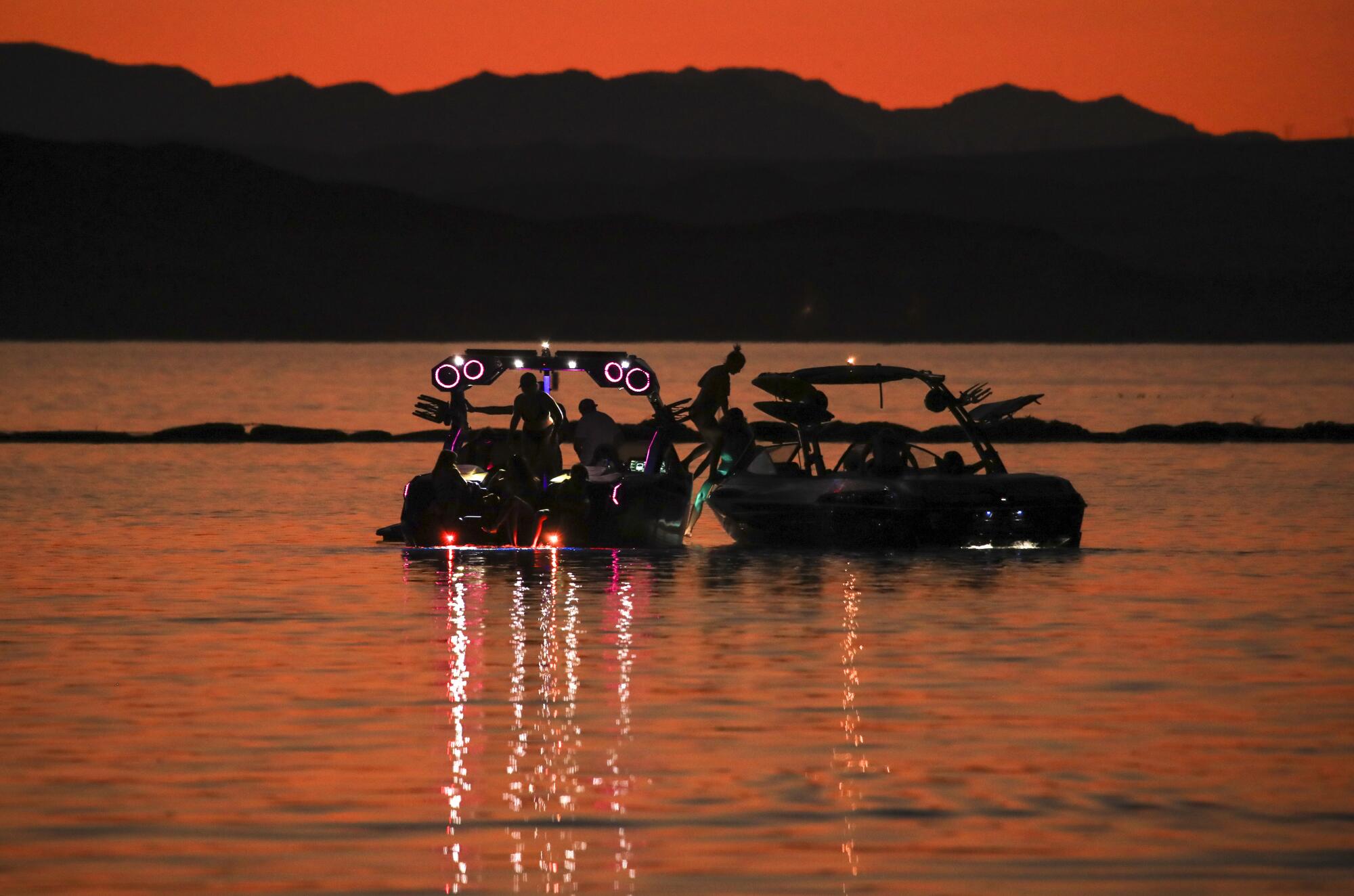 Weekend boaters wait on the water for a launch ramp