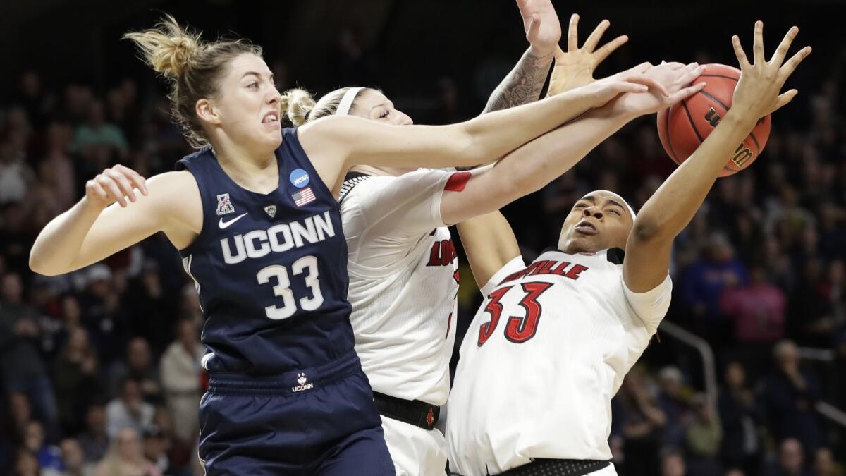 Connecticut guard Katie Lou Samuelson, left, knocks the ball from Louisville's Sam Fuehring, center, and Bionca Dunham during the first half of the Huskies' 80-73 win Sunday.