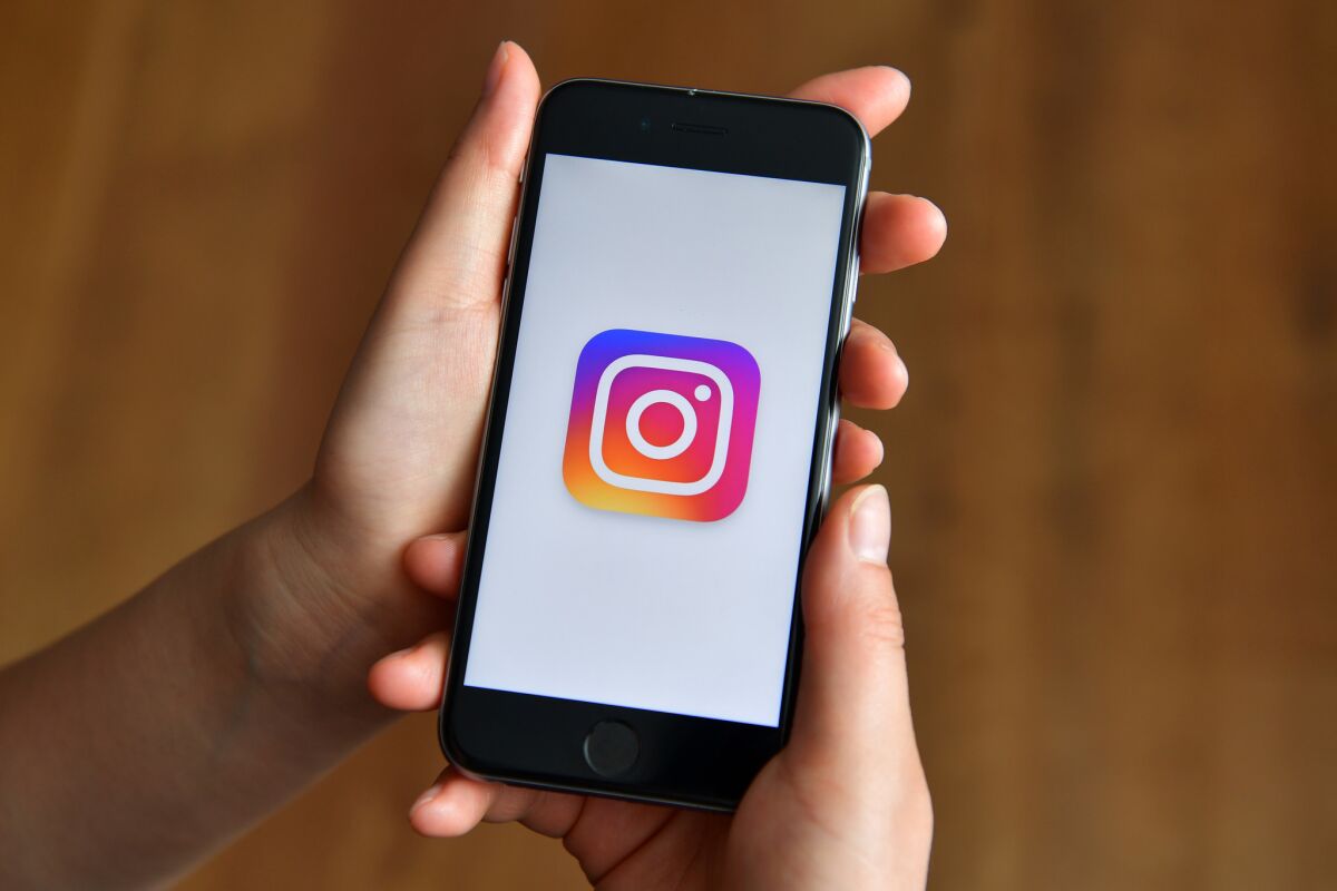 An iPhone displays the Instagram logo.