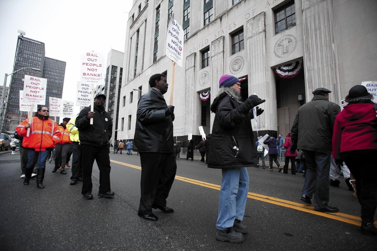 People protest outside the courthouse where U.S. Bankruptcy Judge Steven Rhodes ruled that Detroit was eligible for bankruptcy protection and that its workers’ pensions could be cut.