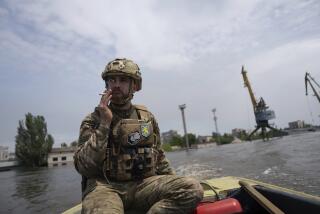 FILE - A Ukrainian serviceman steers a boat in a flooded neighborhood in Kherson, Ukraine, Thursday, June 8, 2023. Floodwaters from a collapsed dam kept rising in southern Ukraine on Wednesday, forcing hundreds of people to flee their homes in a major emergency operation that brought a dramatic new dimension to the war with Russia, now in its 16th month. (AP Photo/Evgeniy Maloletka, File)