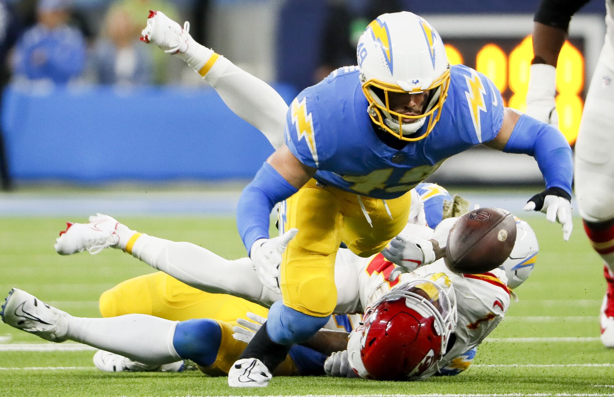 Chargers linebacker Drue Tranquill dives for the ball after a fumble by Chiefs running back Jerick McKinnon.