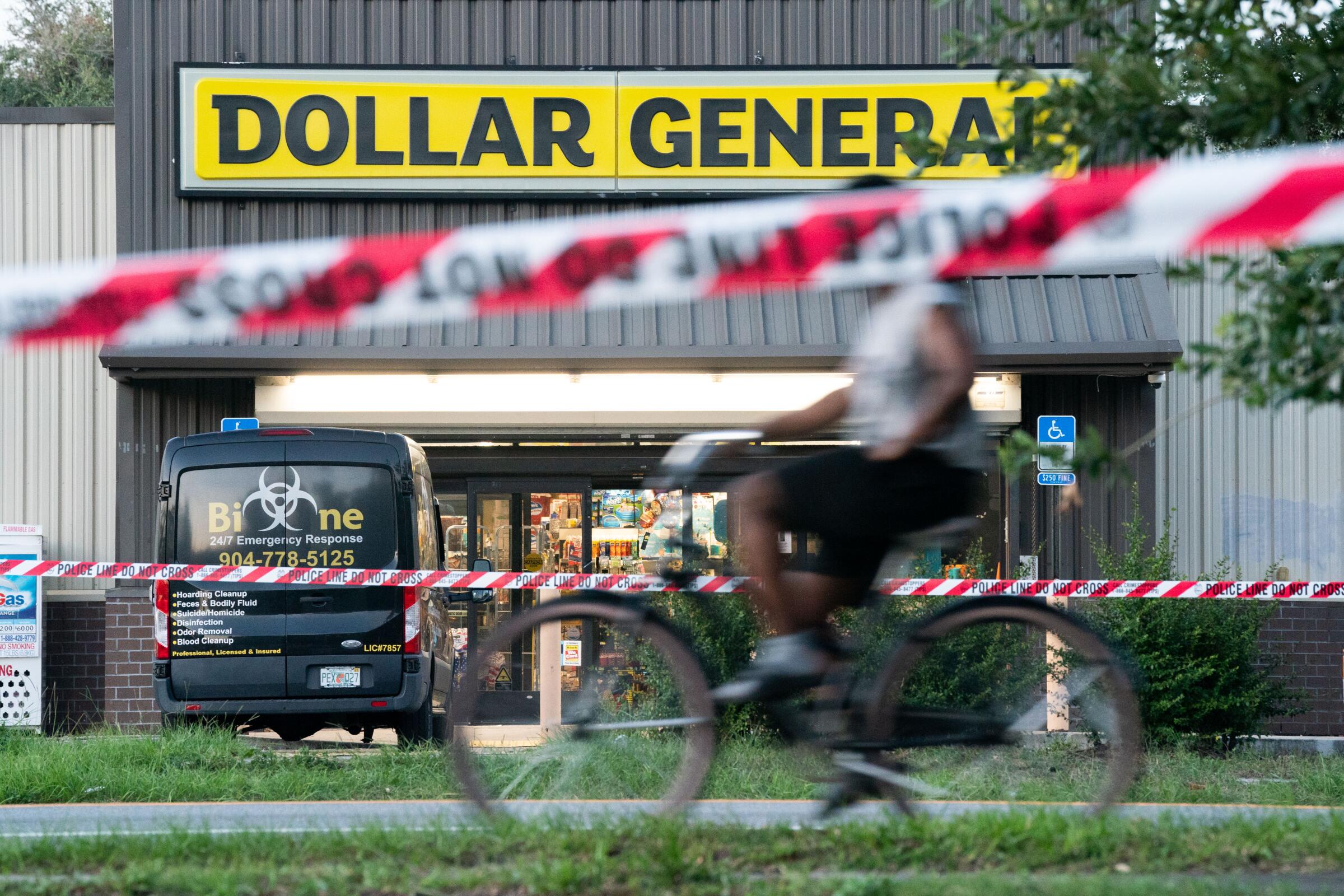 A bicyclist rides past the Dollar General store 