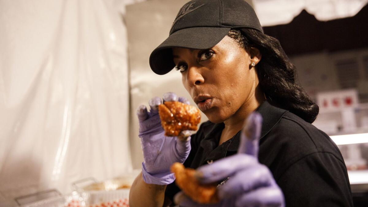 Kim Prince, owner, prepares Nashville Hot Chicken bites from Hotville Chicken during The Taste on the Paramount Studios backlot on Sept. 2.