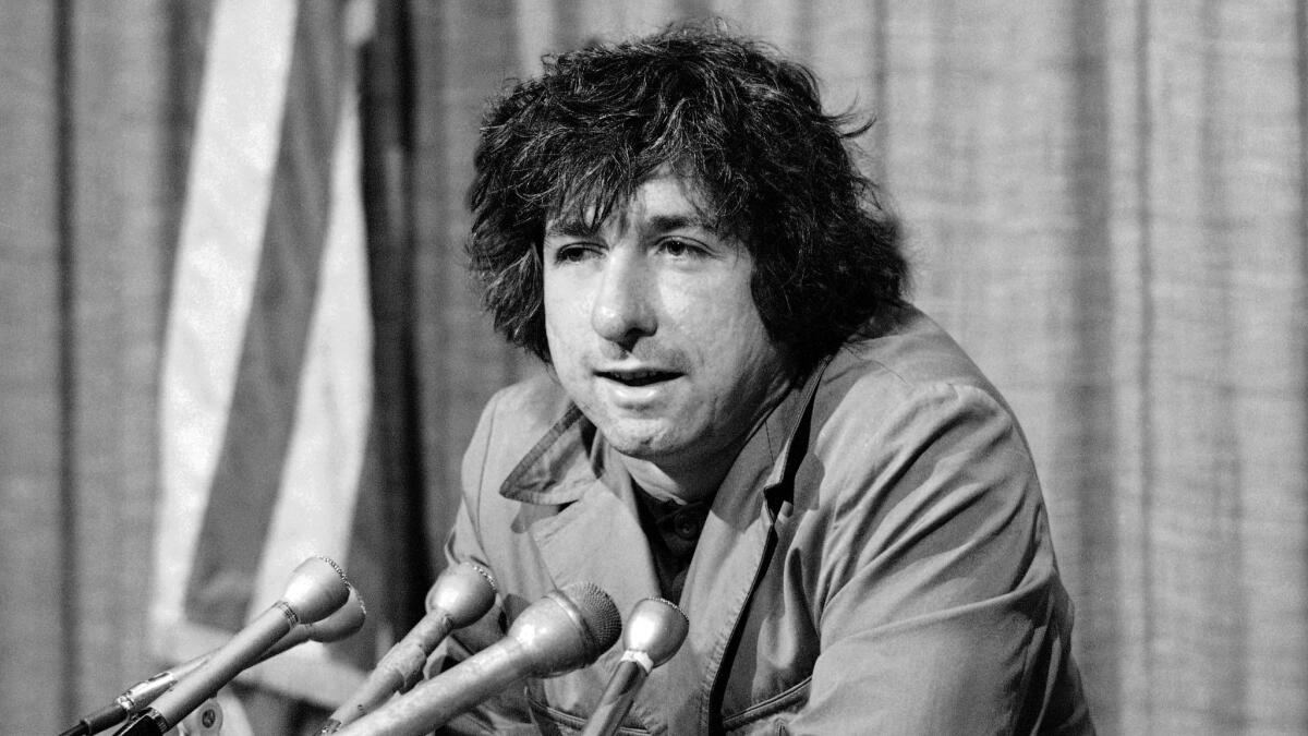 Political activist Tom Hayden conducts a press conference in Los Angeles in 1973.
